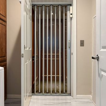 Southeast Elevator - Stainless steel accordion gate with clear panels. - Elevator Services Near Me - Fort Pierce, Florida Southeast Elevator - Stainless steel accordion gate with clear panels. - Elevator Services Near Me - Fort Pierce, Florida