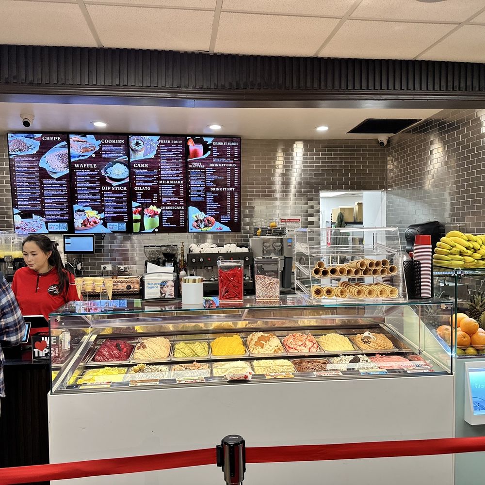 Melt n Dip - a man and a woman standing in front of a counter - Ice Cream & Frozen Yogurt Near Me - Aurora, Illinois