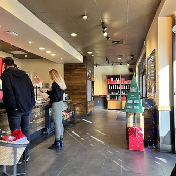Starbucks - two people standing at a counter in a coffee shop - Coffee & Tea Near Me - Asheville, North Carolina