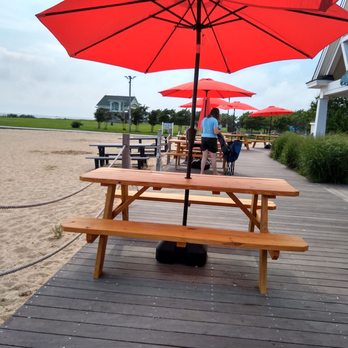 Sully's Wharf - a picnic table with red umbrellas - New American Near Me - Copiague, New York