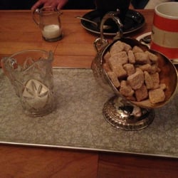 Noah's Yard - Small glass of milk and metal basket of sugar cubes with shovel on the back