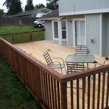 BMS Construction - a deck with a table and chairs - General Contractors Near Me BMS Construction - a deck with a table and chairs - General Contractors Near Me