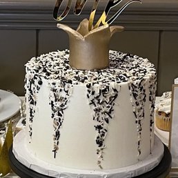 ows a white cake with black and white sprinkles ows a white cake with black and white sprinkles