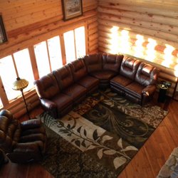 Crane Lake Wilderness Lodge - Large family room with cozy leather furniture and windows surrounding two full walls with views facing east and south