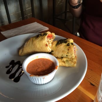 Rocky Mountain Flatbread Co - Chicken calzone with roasted pepper sauce - Pizza Near Me - Canmore, Alberta Rocky Mountain Flatbread Co - Chicken calzone with roasted pepper sauce - Pizza Near Me - Canmore, Alberta