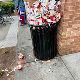 a trash can on the sidewalk a trash can on the sidewalk