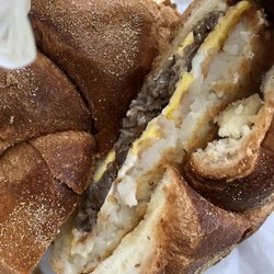 Steak egg and cheese with hash brown breakfast sandwich
