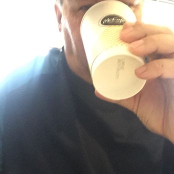 McDonald's - a man drinking a cup of coffee - Burgers Near Me - Natrona Heights, Pennsylvania