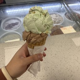 Pistachio & milk chocolate ice cream on a waffle cone Pistachio & milk chocolate ice cream on a waffle cone