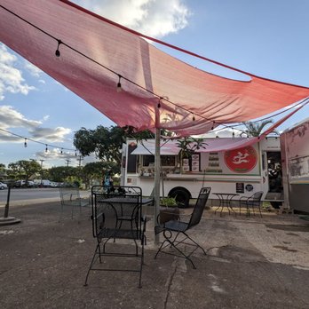 Mediterranean Grill - a table and chairs under a shade - Food Trucks Near Me - Haiku, Hawaii