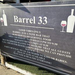 The signage at the front of the restaurant. The metal bell that you ring to get in can be seen at the top left of the sign.