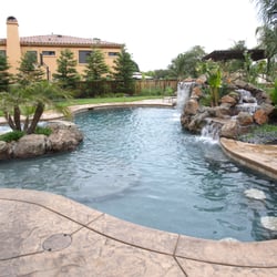 Fusion Pool & Spa - Who doesn't want a waterfall in their backyard? How about a few underwater seats at the edge of the pool?
