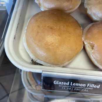 Krispy Kreme - A wasp in the donut display climbing into the filling - Donuts Near Me - Melbourne, Florida