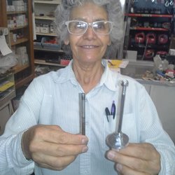 Second Chance Lumber Yard - Owner/operator Rosie holding the vastly superior parts that enabled me to continue pedaling my immensely adjusted biketour!