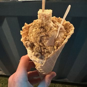 Tizzy K’s Cereal Ice Cream - Reese's Puffs 2 scoop ice cream in waffle cone, finished with Rice Krispie treat - Ice Cream & Frozen Yogurt Near Me - Providence, Rhode Island Tizzy K’s Cereal Ice Cream - Reese's Puffs 2 scoop ice cream in waffle cone, finished with Rice Krispie treat - Ice Cream & Frozen Yogurt Near Me - Providence, Rhode Island