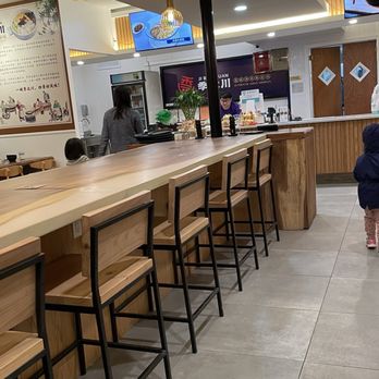 Ji Bei Chuan - a woman and a child in a restaurant - Chinese Near Me - Bayside, New York Ji Bei Chuan - a woman and a child in a restaurant - Chinese Near Me - Bayside, New York