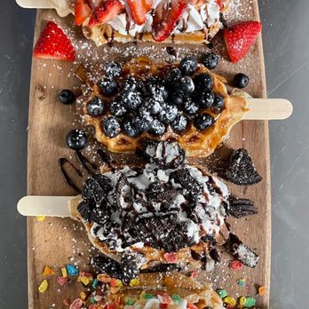 Mama Lama - Four of our famous Waffle Pops.. top to bottom: Strawberries & Cream, Blueberry Honey, Oreo, and Fruity Pebbles - Desserts Near Me - Dallas, Texas Mama Lama - Four of our famous Waffle Pops.. top to bottom: Strawberries & Cream, Blueberry Honey, Oreo, and Fruity Pebbles - Desserts Near Me - Dallas, Texas