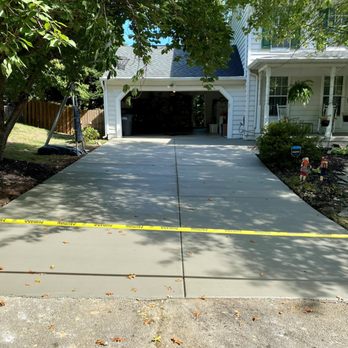 John Boothe Concrete - a driveway with yellow tape - General Contractors Near Me - Manassas, Virginia John Boothe Concrete - a driveway with yellow tape - General Contractors Near Me - Manassas, Virginia