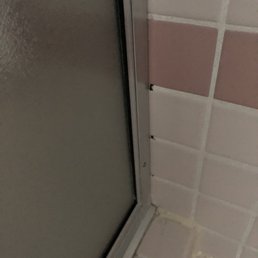 Shower with dark spots on white grout Shower with dark spots on white grout