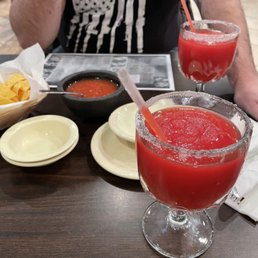 Strawberry margaritas that we got in a pitcher, salsa, chips and cheese dip.