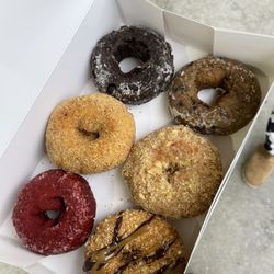Dough N Joe - Half Dozen left to right; Red Velvet, Crushed peanuts, chocolate, Samoa, coffee crumb, blueberry