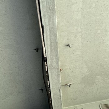J&E ROOFING - Before - screws through roof from satellite mounting. - Roofing Near Me - Waianae, Hawaii