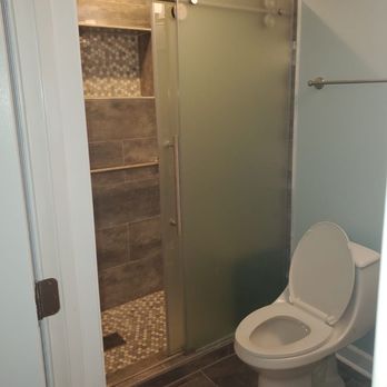 Kasey Homes LLC - Complete bathroom remodel. We installed new flooring, new tile in the shower, shower door, new lighting, painting, and fixtures. - General Contractors Near Me