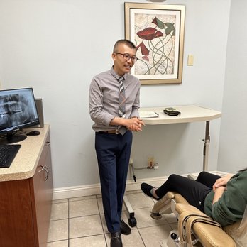 Pacifica Oral & Maxillofacial Surgery - Doctor Le going over the procedure and answering our questions. I snuck a photo in, might have caught him off guard. - Oral Surgeons Near Me - Anaheim, California Pacifica Oral & Maxillofacial Surgery - Doctor Le going over the procedure and answering our questions. I snuck a photo in, might have caught him off guard. - Oral Surgeons Near Me - Anaheim, California