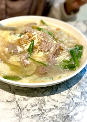 Photo of Madam Kwan's - Kuala Lumpur, 14, MY. This beef noodle was thick and generously filled with beef slices. I would pick this on a rainy day.