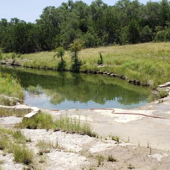 Sky Park RV Ranch - The swimming hole with a gentle stream running into it - RV Parks Near Me - Liberty Hill, Texas