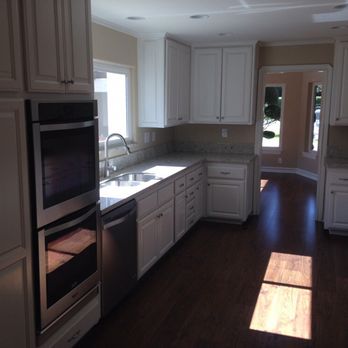 Ryco Renovation - a kitchen with white cabinets and stainless steel appliances - General Contractors Near Me - Riverside, California Ryco Renovation - a kitchen with white cabinets and stainless steel appliances - General Contractors Near Me - Riverside, California