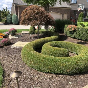 Haro Landscape Services - a front yard with a circular garden - Landscaping Near Me