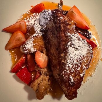 Toulouse Petit Kitchen & Lounge - Crème Caramel French Toast with strawberries and pecan butter - Seafood Near Me - Seattle, Washington Toulouse Petit Kitchen & Lounge - Crème Caramel French Toast with strawberries and pecan butter - Seafood Near Me - Seattle, Washington