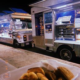 a food truck and a container of hot dogs a food truck and a container of hot dogs