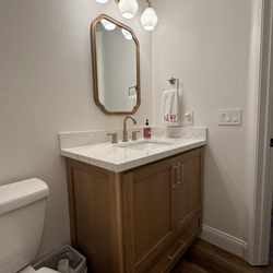 The Shine Stone - Bathroom vanity and under-mount sink with 4" splash guard. Cambria Everleigh Quartz.