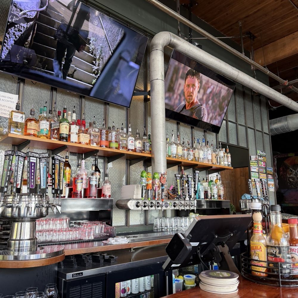 Elysian Brewing - Capitol Hill - Sitting at the bar while watching some TV. - Brewpubs Near Me - Seattle, Washington