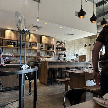 Bufalina Due - a man standing in a restaurant - Pizza Near Me - Austin, Texas