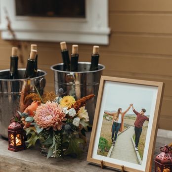 Union Hotel Restaurant - a picture of a man and a woman standing in front of a table with wine bottles and flowers - Italian Near Me - Occidental, California