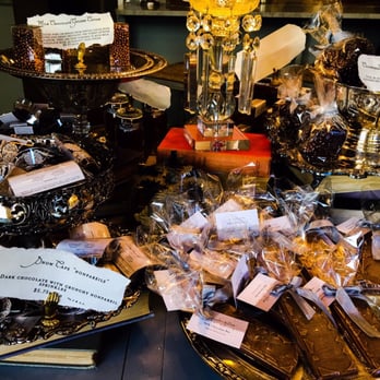 Chocolat by Adam Turoni - Your first impression will look like this. A table with various chocolate to invite you in :-)! - Desserts Near Me - Savannah, Georgia Chocolat by Adam Turoni - Your first impression will look like this. A table with various chocolate to invite you in :-)! - Desserts Near Me - Savannah, Georgia