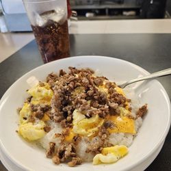 Waffle House - Scrambled eggs, grits, cheese slice, and chopped sausage on top!