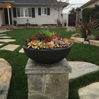AL Lopez Landscaping - Sydney Peak flagstone column with drip system and small accent light in succulent pot. - Landscaping Near Me