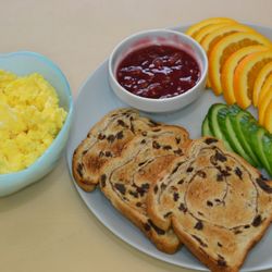 Happy Child Preschool and Daycare - Yummy breakfast of eggs, cucumber, toast, jam and oranges.