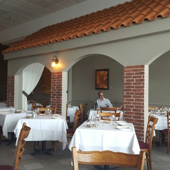 Restaurant Terracina - a man sitting at a table - Italian Near Me - Laval, Quebec Restaurant Terracina - a man sitting at a table - Italian Near Me - Laval, Quebec