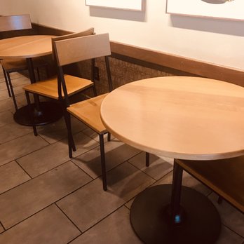 Starbucks - Nice tables to sit at. There are also electrical outlets behind most tables where you can plug in your laptop - Coffee & Tea Near Me - Garner, North Carolina
