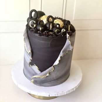 Fruitique - a chocolate cake decorated with black and gold decorations - Chocolatiers & Shops Near Me Fruitique - a chocolate cake decorated with black and gold decorations - Chocolatiers & Shops Near Me