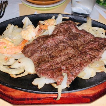 Chavez Mexican Cafe - a steak on a plate with onions and shrimp - Mexican Near Me - Houston, Texas Chavez Mexican Cafe - a steak on a plate with onions and shrimp - Mexican Near Me - Houston, Texas