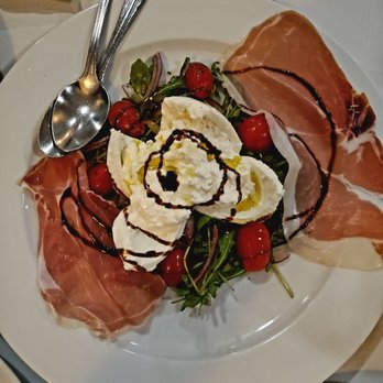 Spolini's - Burrata con Prosciutto, w/ Arugula, Tomato, Red Onion, and Balsamic Reduction - Italian Near Me - Kew Gardens, New York Spolini's - Burrata con Prosciutto, w/ Arugula, Tomato, Red Onion, and Balsamic Reduction - Italian Near Me - Kew Gardens, New York