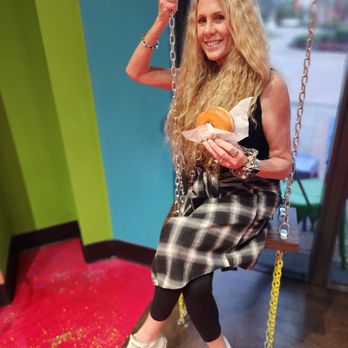 Hurts Donut - Me on the swing with a glazed donut - Donuts Near Me - Plantation, Florida