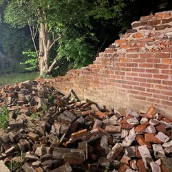 Myers Real Estate - Partially collapsed (and leaning) brick wall bordering the sidewalk used to access homes in our building