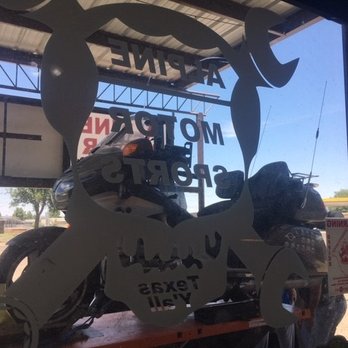 Alpine Motorsports - Bike on lift through Alpine's window - Motorcycle Repair Near Me - Alpine, Texas